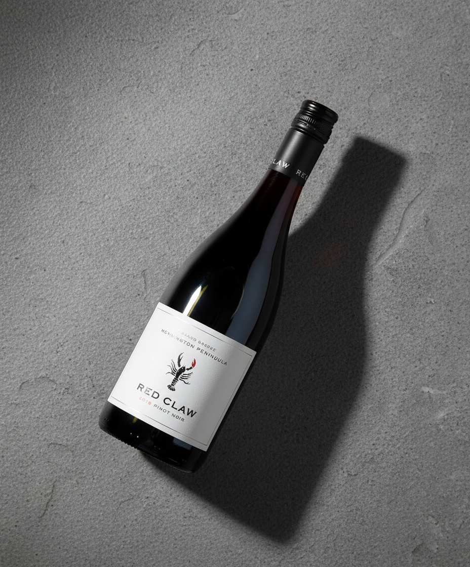 Red Claw Pinot Noir 2023 bottle on gray textured surface with shadow, gallery position 5 portrait view
