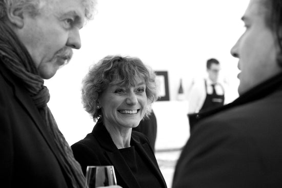 Smiling lady and gentleman chatting at a tasting